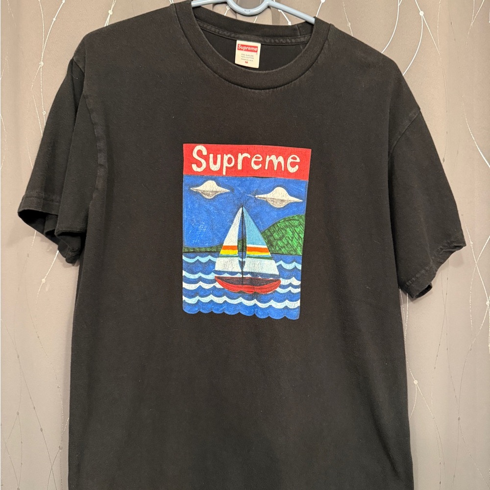 Supreme Black Tee with Vibrant Sailboat Graphic